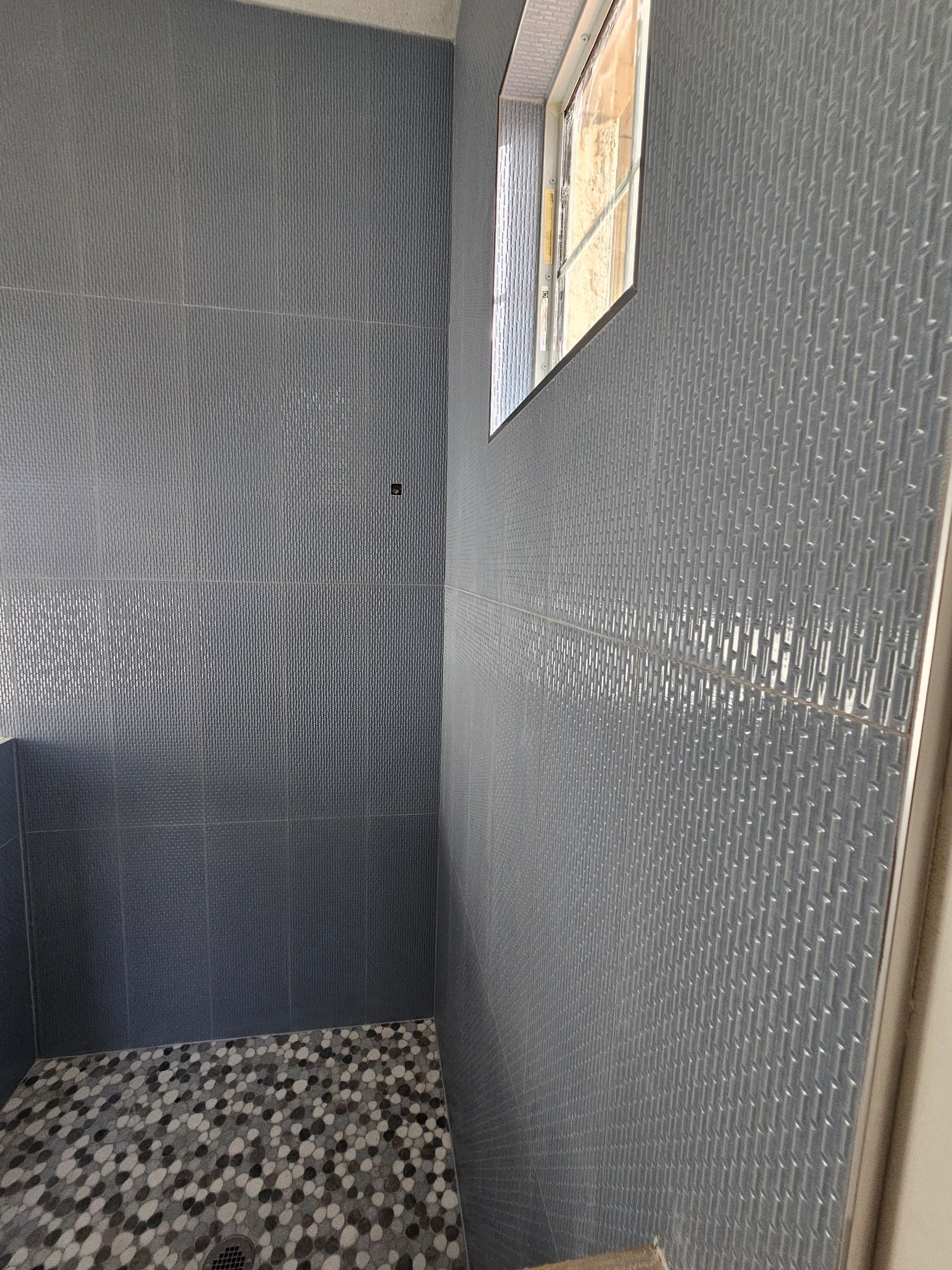 Luxury bathroom with turquoise scallop tile and freestanding tub