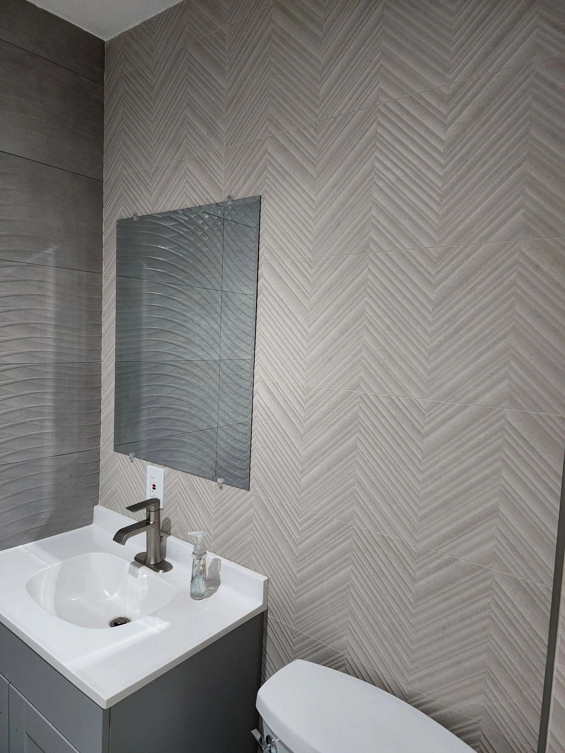 Herringbone gray marble tile bathroom